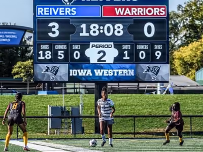 Soccer scoreboard shows Reivers leading Warriors 3-0 in period 2 with 18:08 left and players on field.
