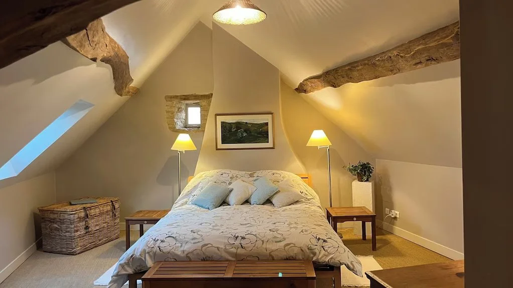   An incredibly comfortable and quiet bedroom with a lot of space, an oversized dresser, and lovely decor.  