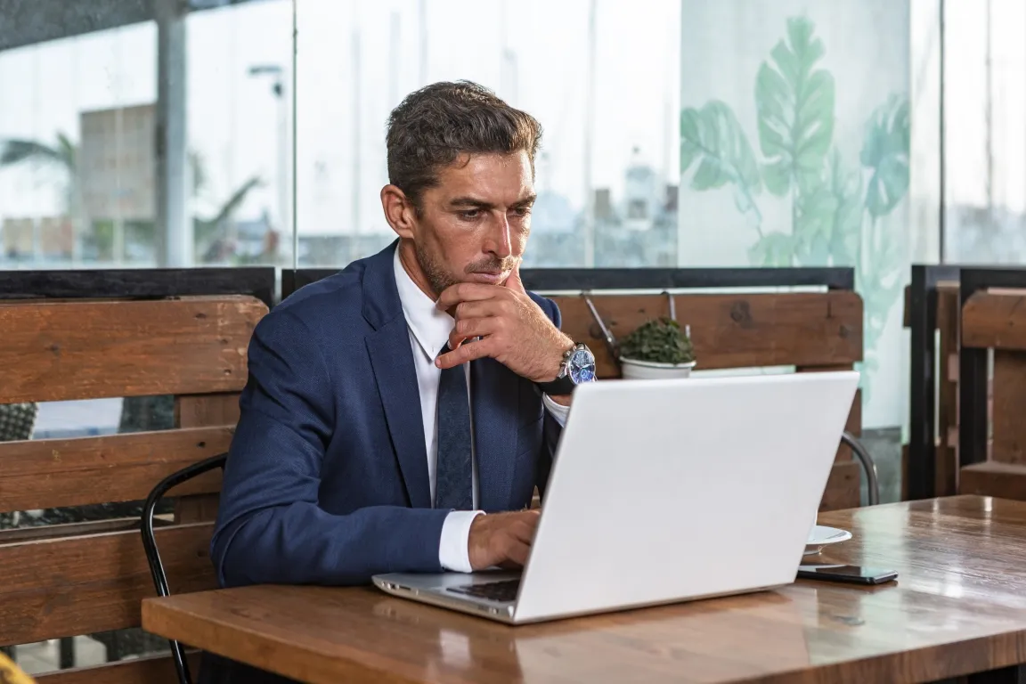 Middle aged business professional on a laptop