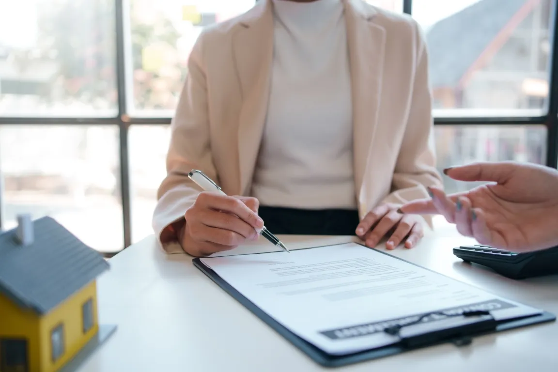 Two individuals engaged in discussing paperwork.