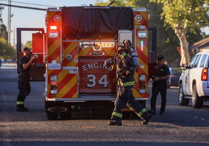 Lincoln fire fighters responding with Engine 34 on a residential street
