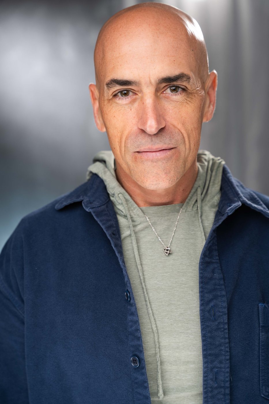 Nick Jude in a navy chore jacket smiling