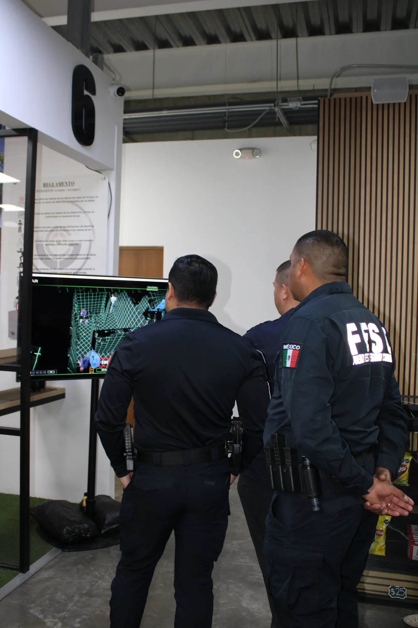 Oficiales observando un sistema de simulación de entrenamiento táctico con detección de objetivos en tiempo real