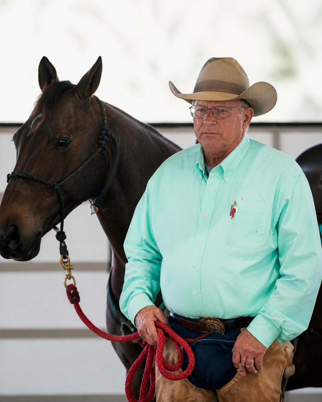 Derrell Cox standing beside a horse