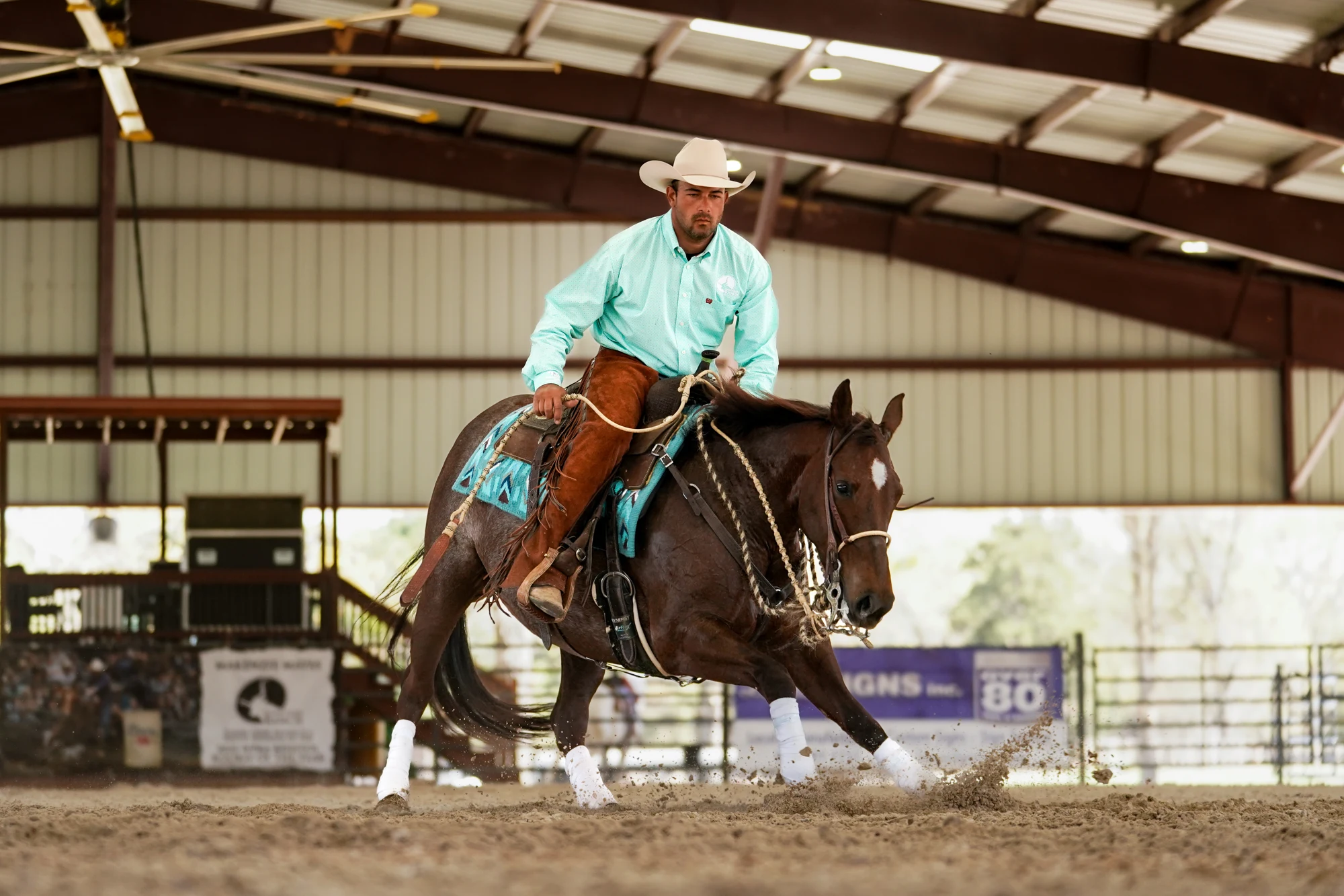 Daniel Oliveira guiding a Timber Creek horse through a turn in the arena