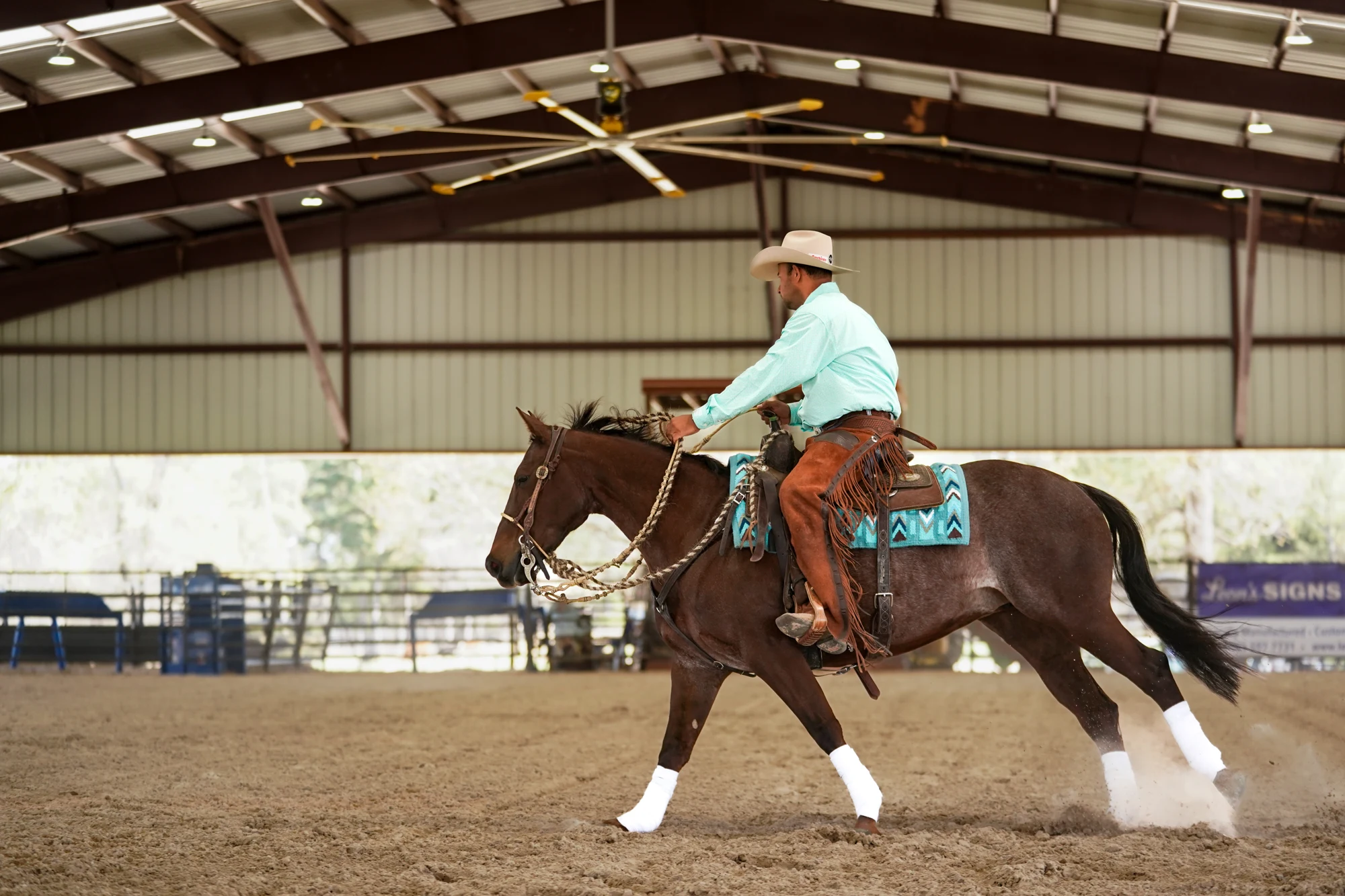 Daniel Oliveira riding a Timber Creek performance horse in the covered arena