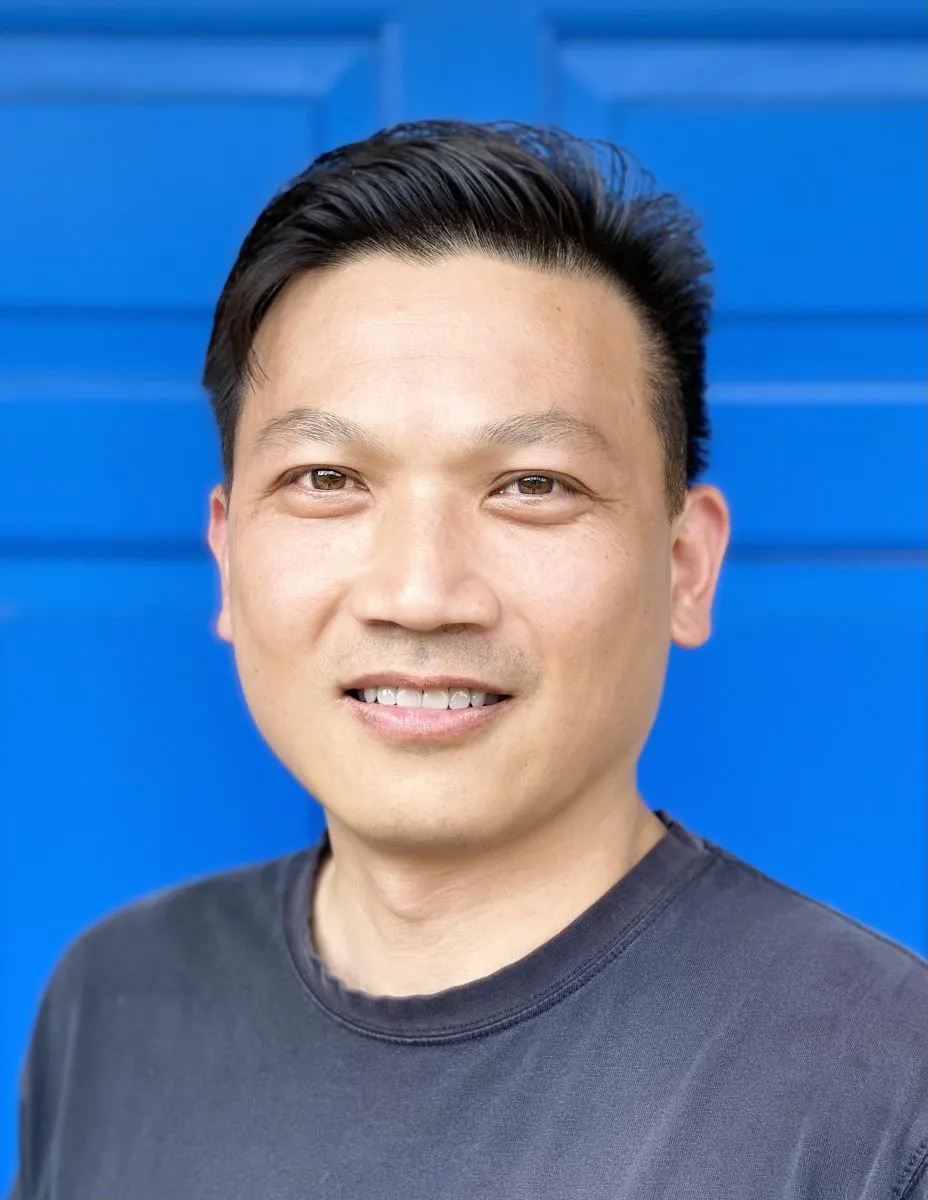 Portrait of a smiling man against a blue background