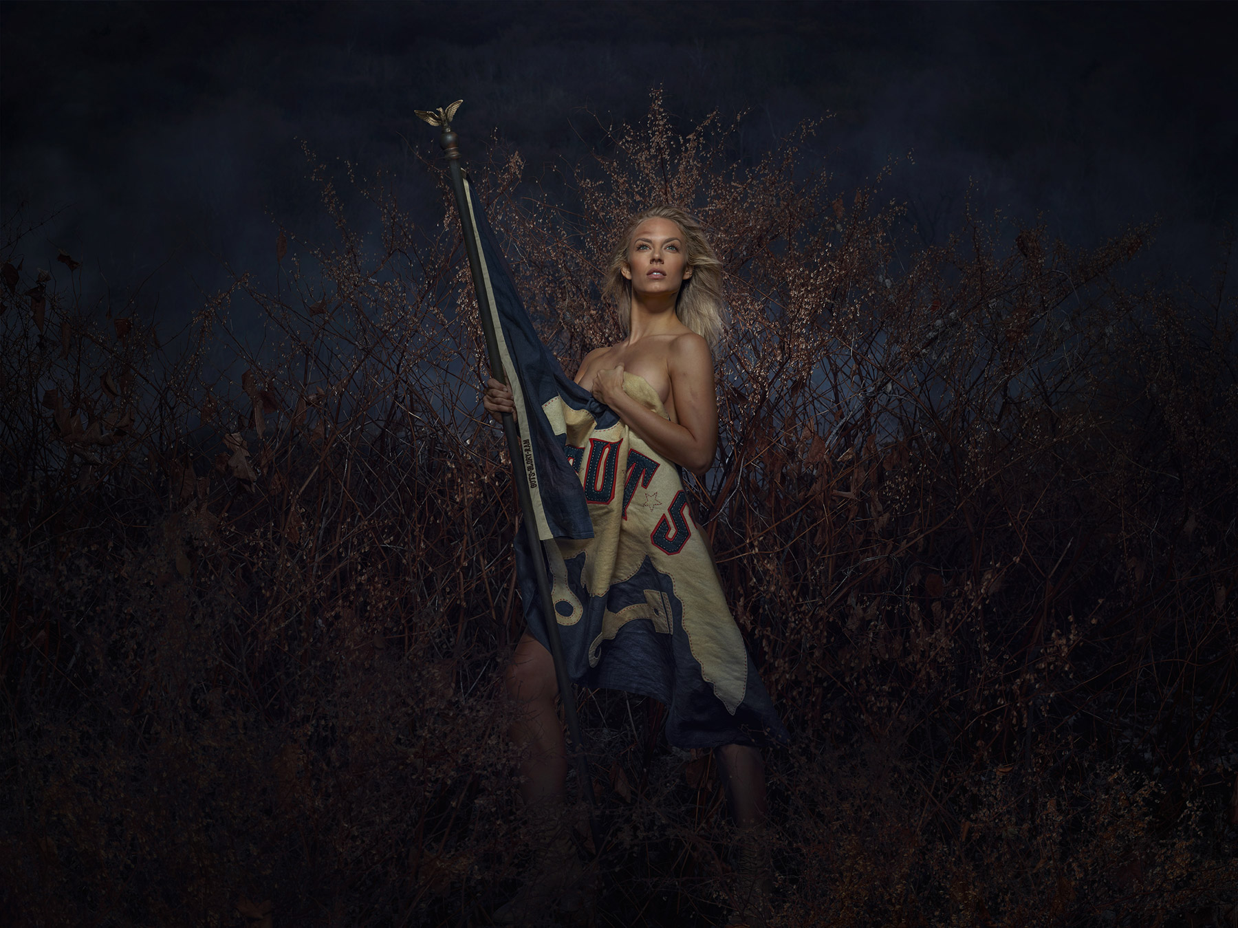 A naked woman wrapped in a Guts flag created by Johnathan Wynn and The Richards Group for Dodge Ram
