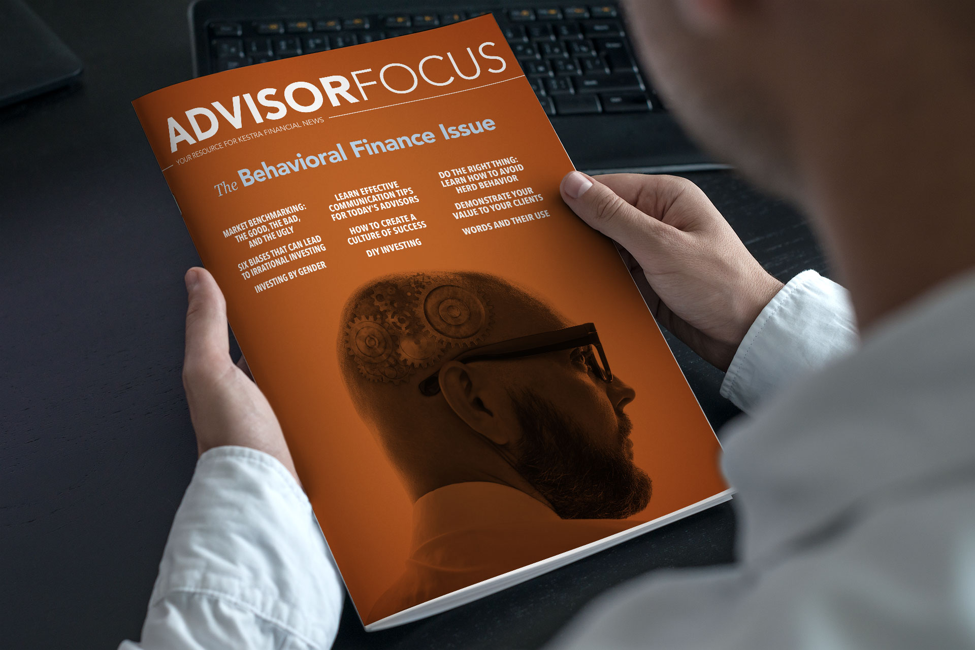 A man reading a redesigned Kestra Financial magazine by Johnathan Wynn Design