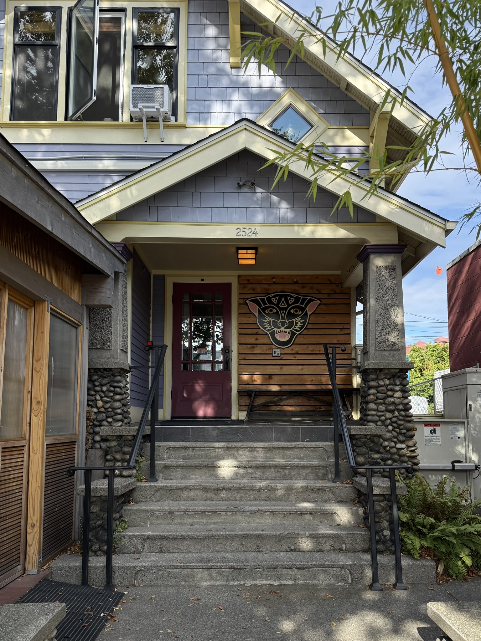 Entrance to Musang, Seattle, with the restaurant's civet-cat mascot