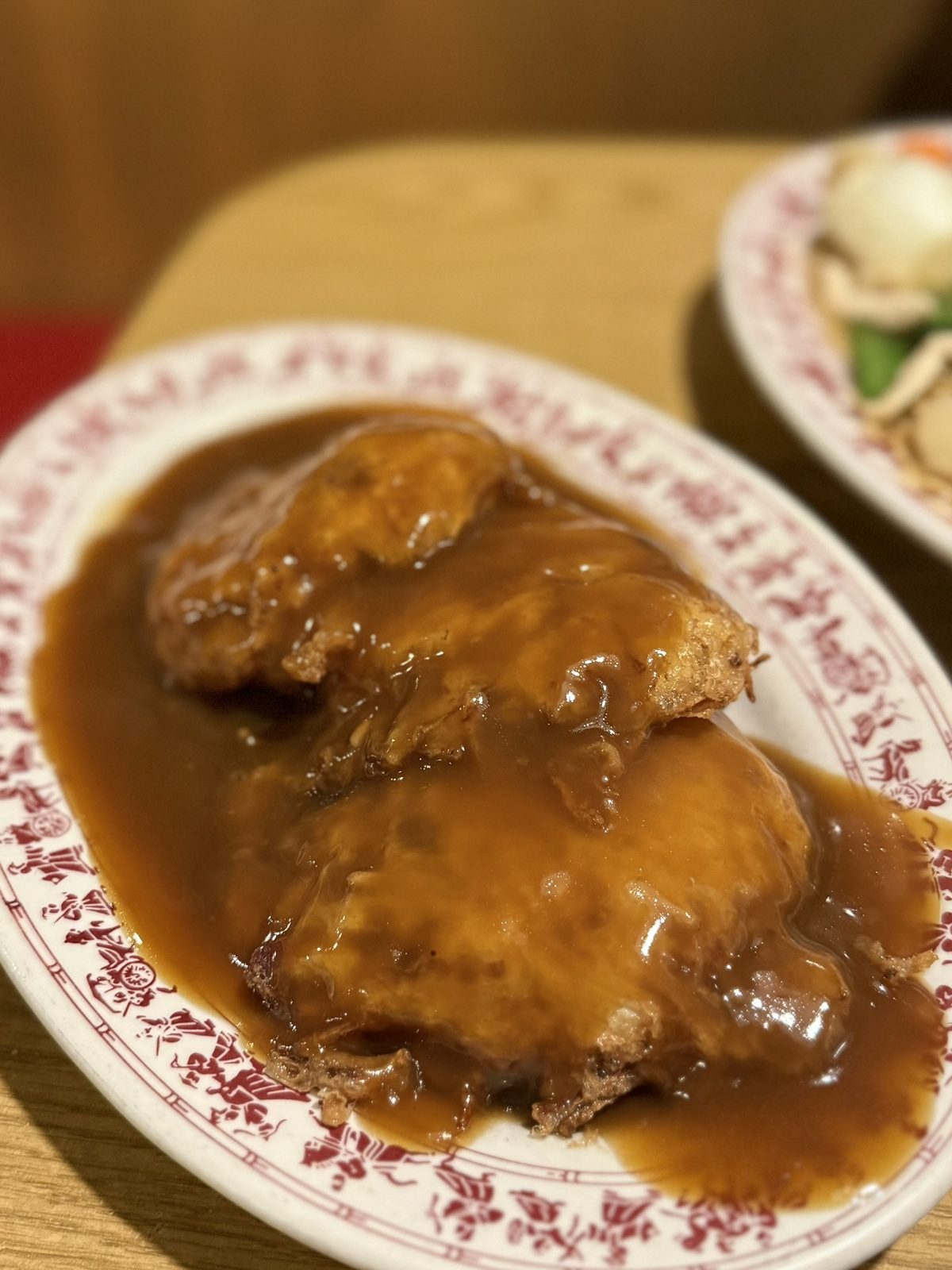 Pork Egg Foo Young at Tai Tung, blanketed in dark, glossy gravy