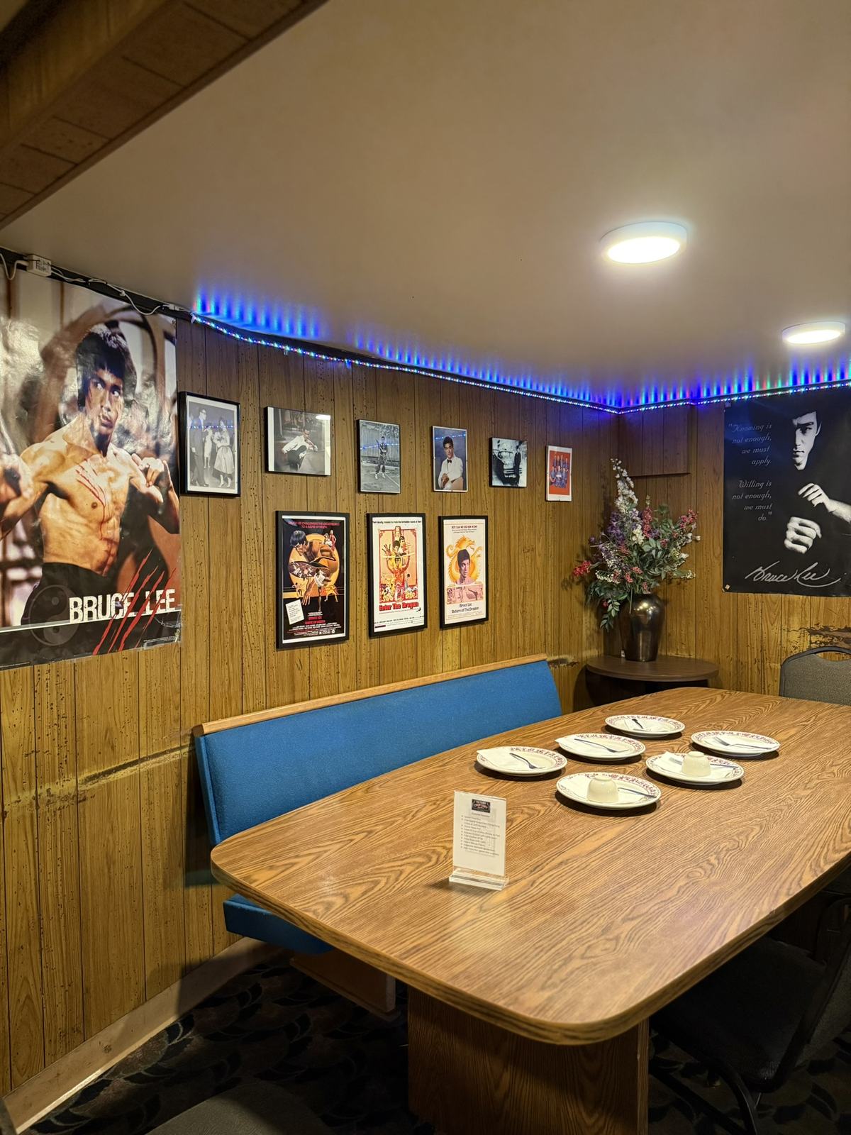 A small memorial to Bruce Lee in the back corner of Tai Tung, posters and photos covering the wall