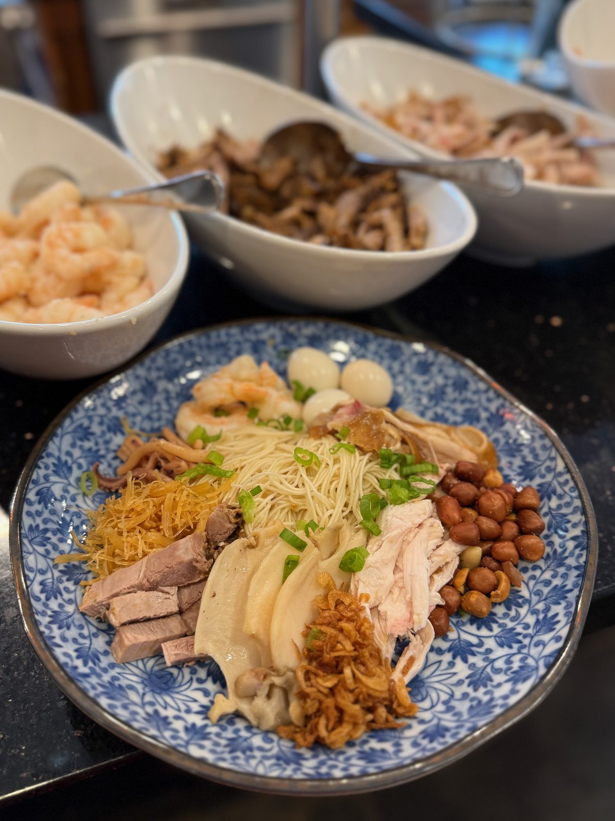 A built plate of Tsa Misua with the serving bowls behind it