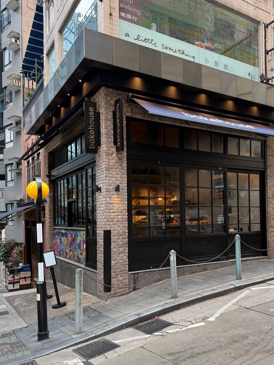 A corner bakery shopfront in Hong Kong before opening, the street outside quiet