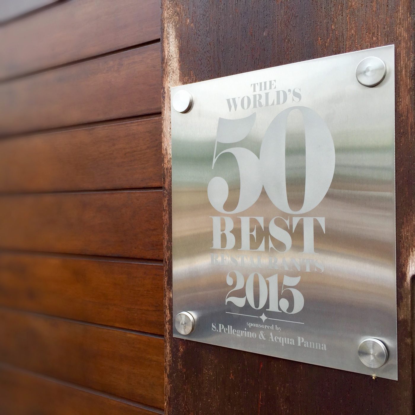 A World's 50 Best Restaurants 2015 plaque fixed to the gate frame at the entrance to Maido in Lima.