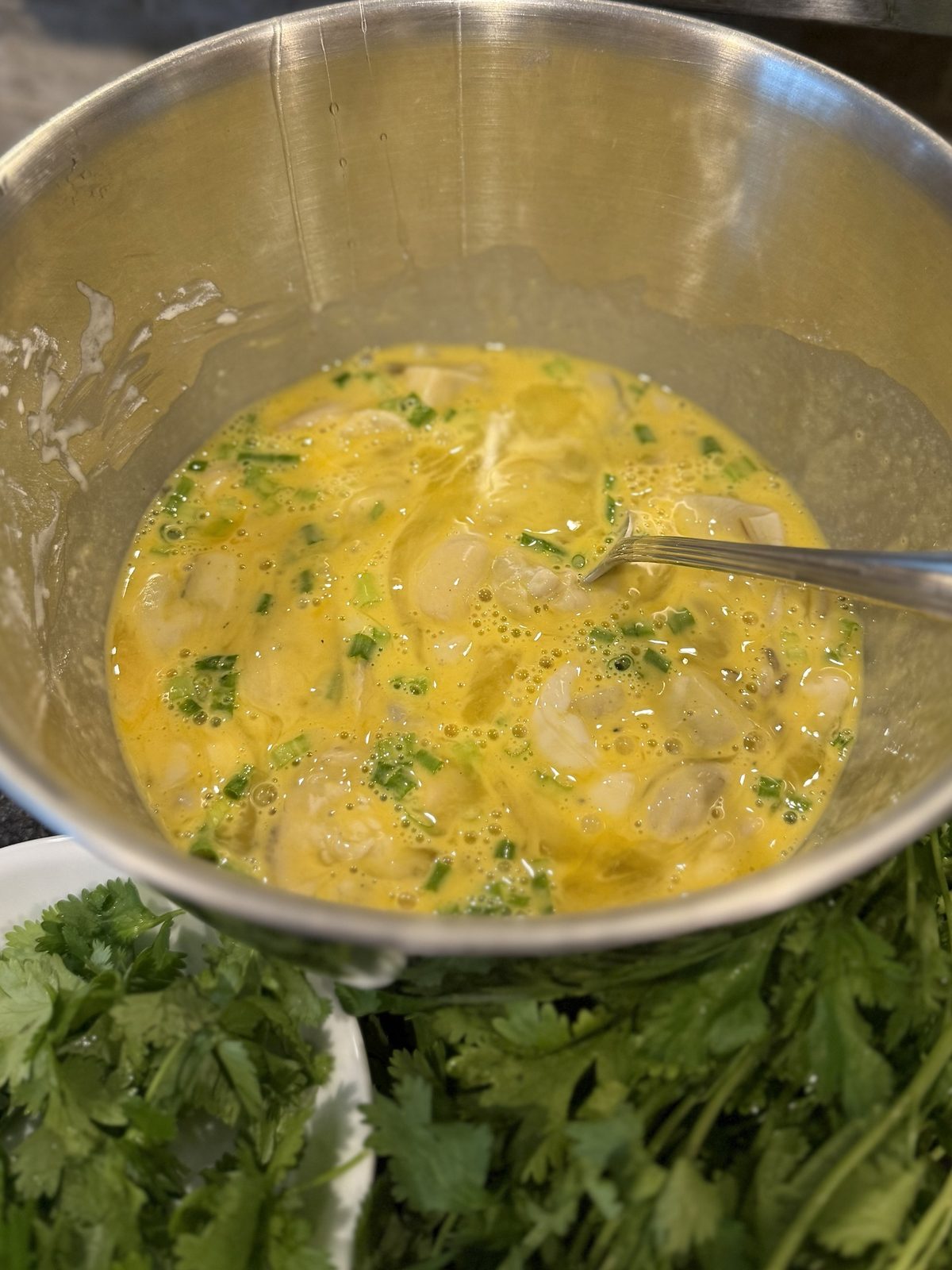 Oysters and green onion folded into the egg batter with a spoon