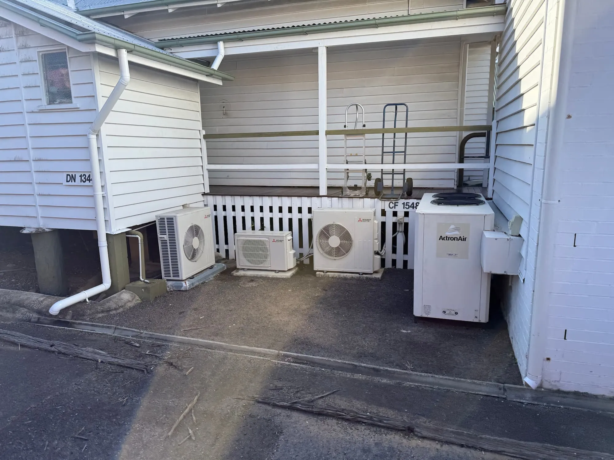 Air conditioning condenser units on a concrete hard stand at a Toowoomba commercial property