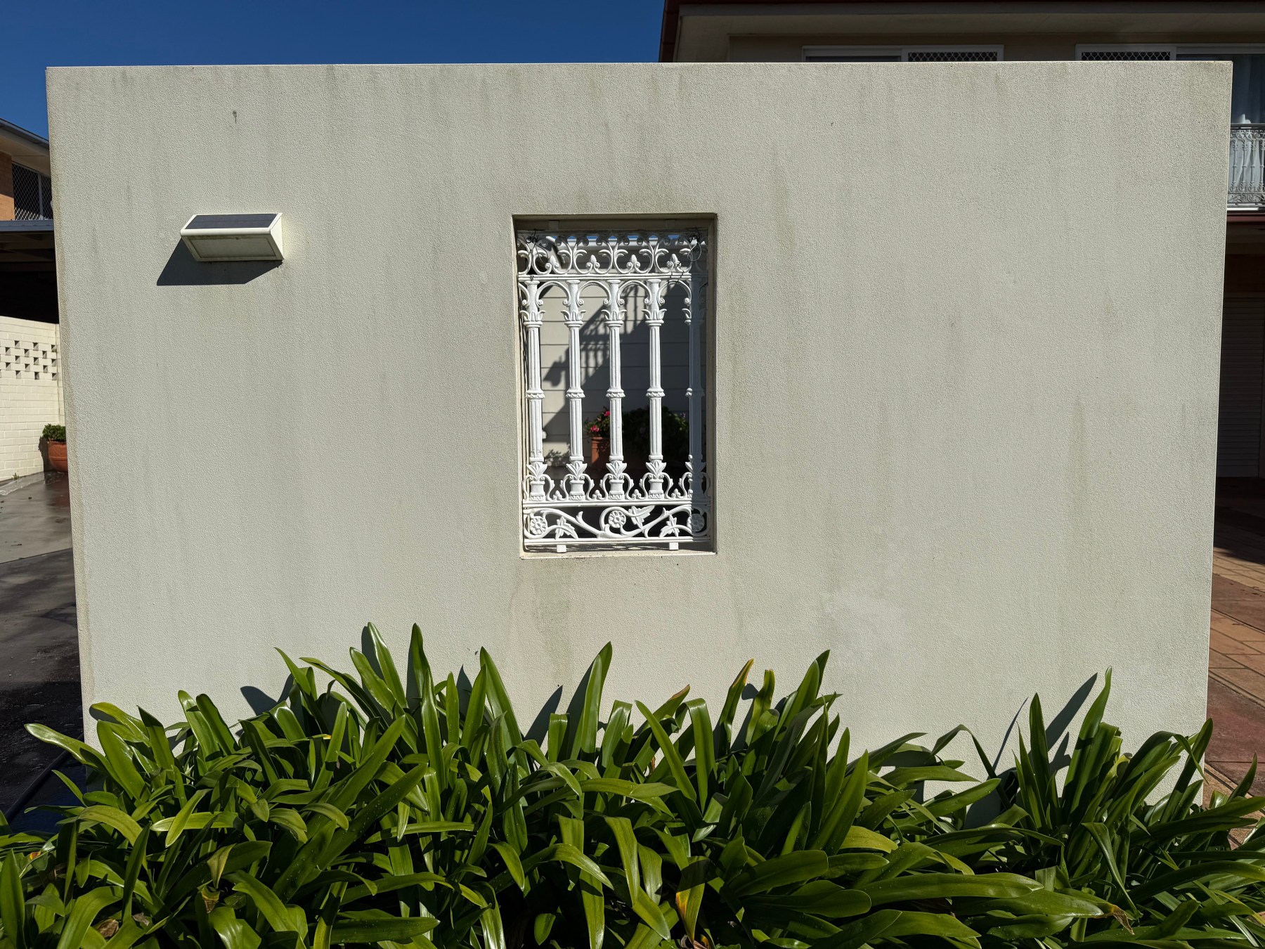 Rendered front wall and decorative window cleaned back to an even finish