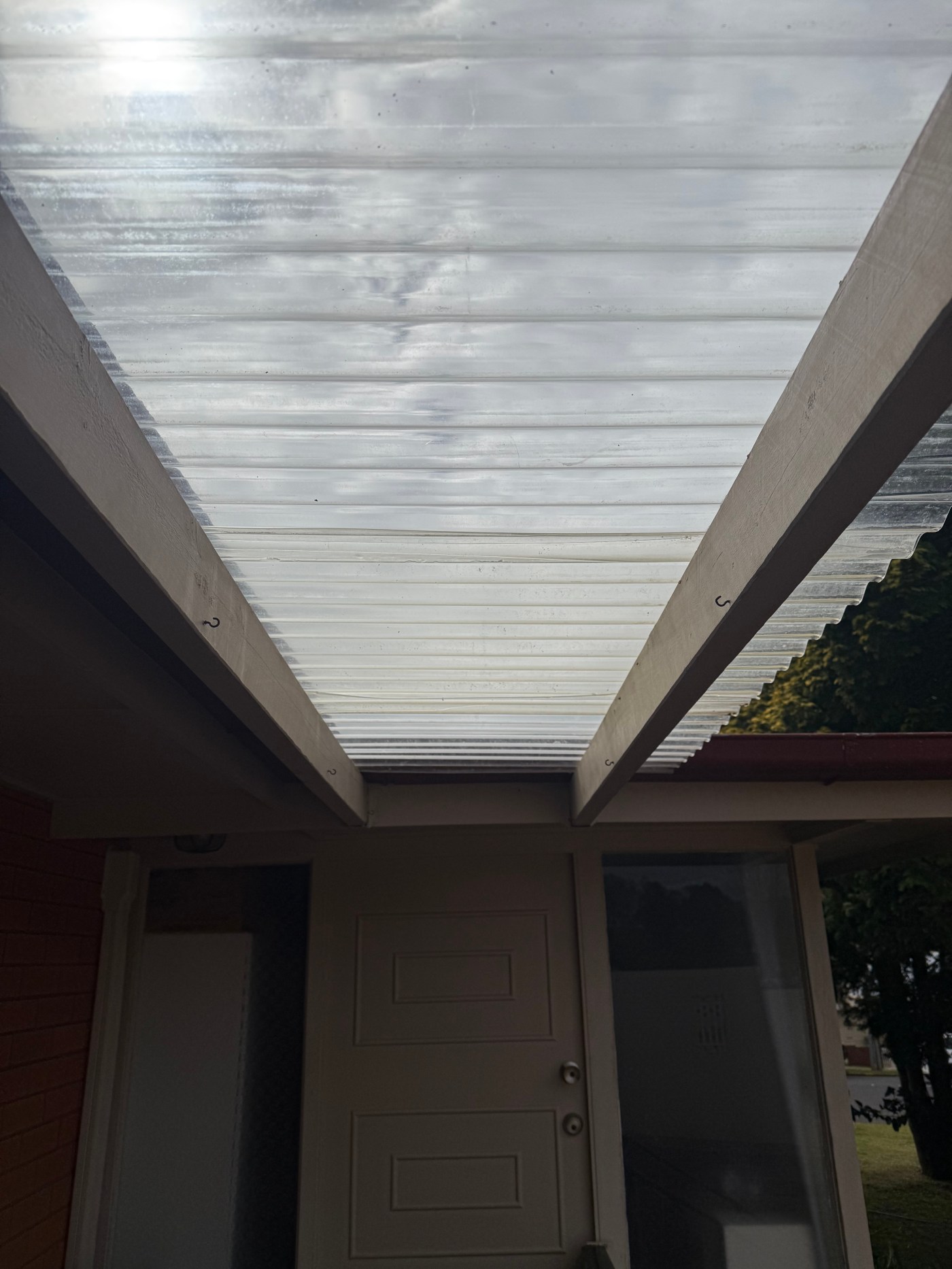 Polycarbonate patio roofing cleaned of dirt and algae
