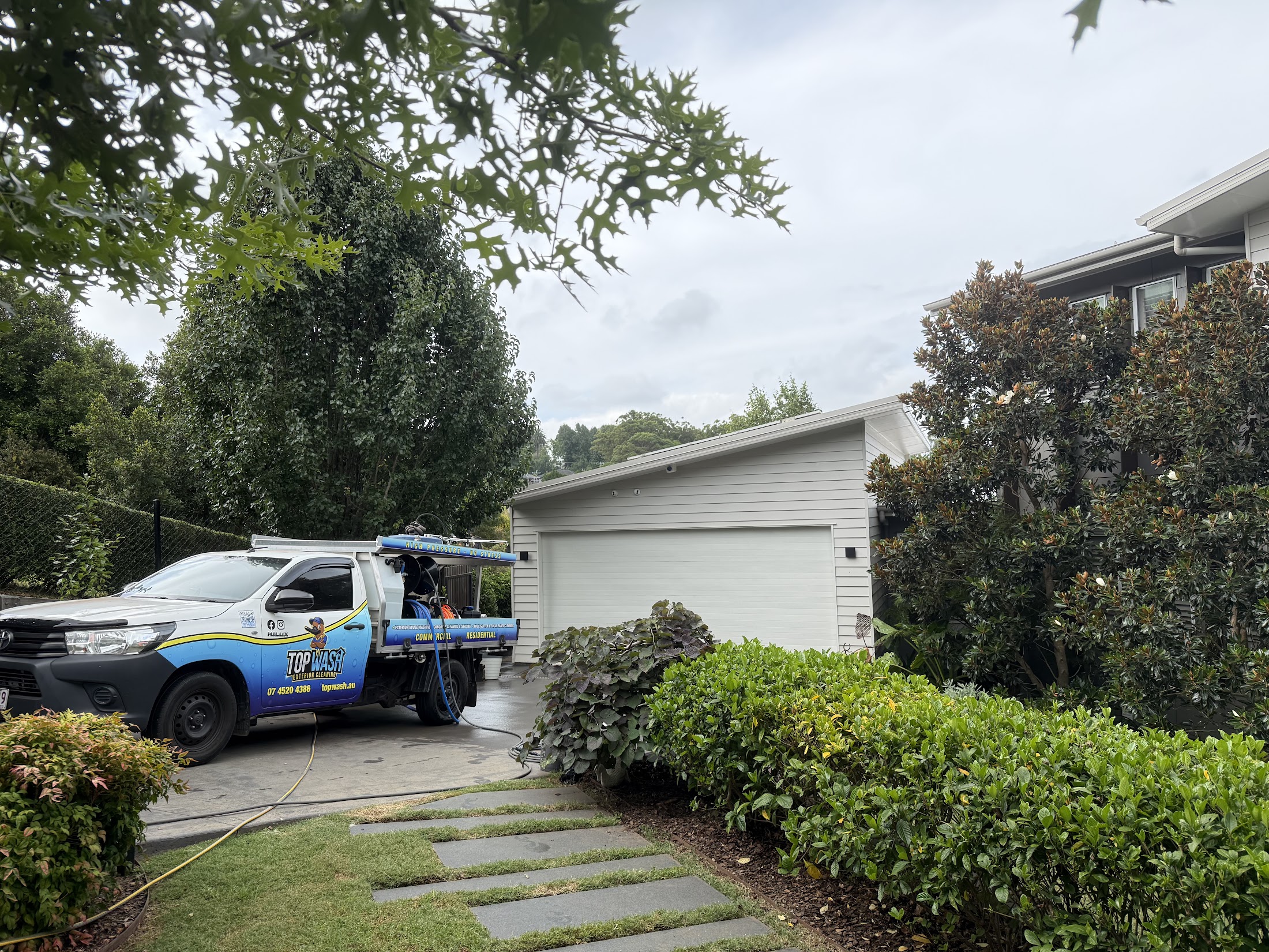 TopWash branded ute and pressure cleaning rig parked at a Toowoomba job