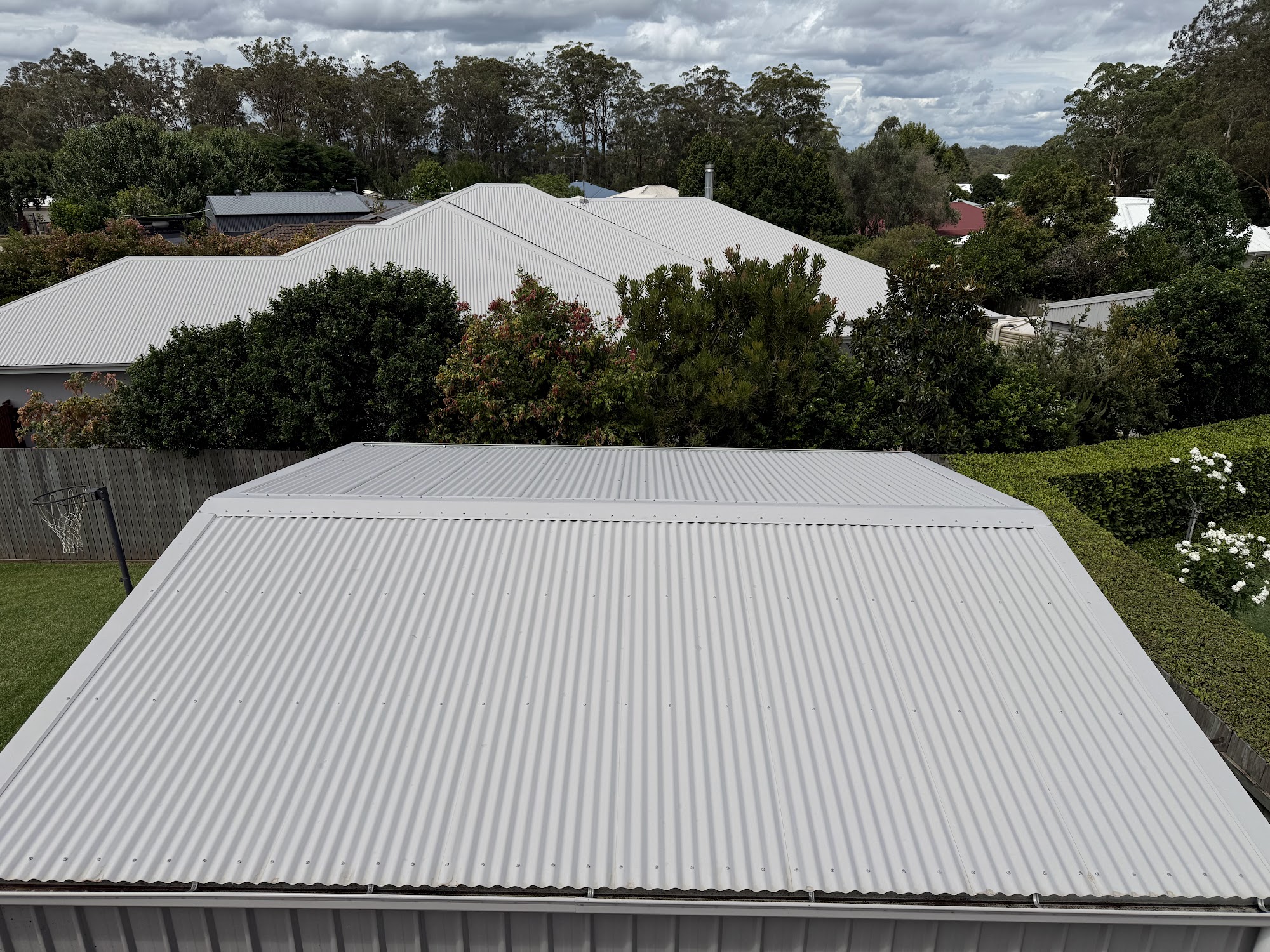 Colorbond roof cleaned back to white, with neighbouring Toowoomba rooftops behind
