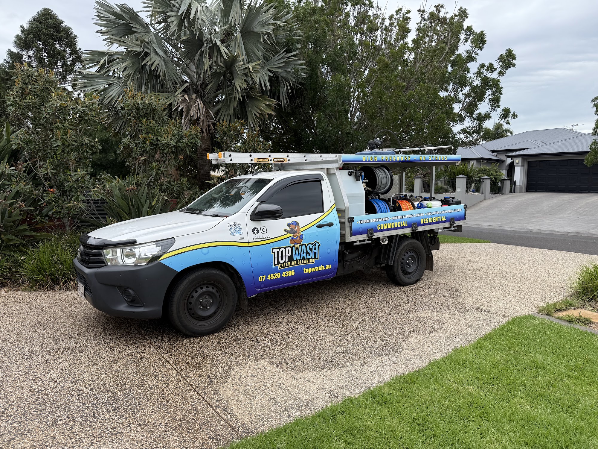 TopWash Hilux with ladders and gear parked on an exposed aggregate driveway in Toowoomba