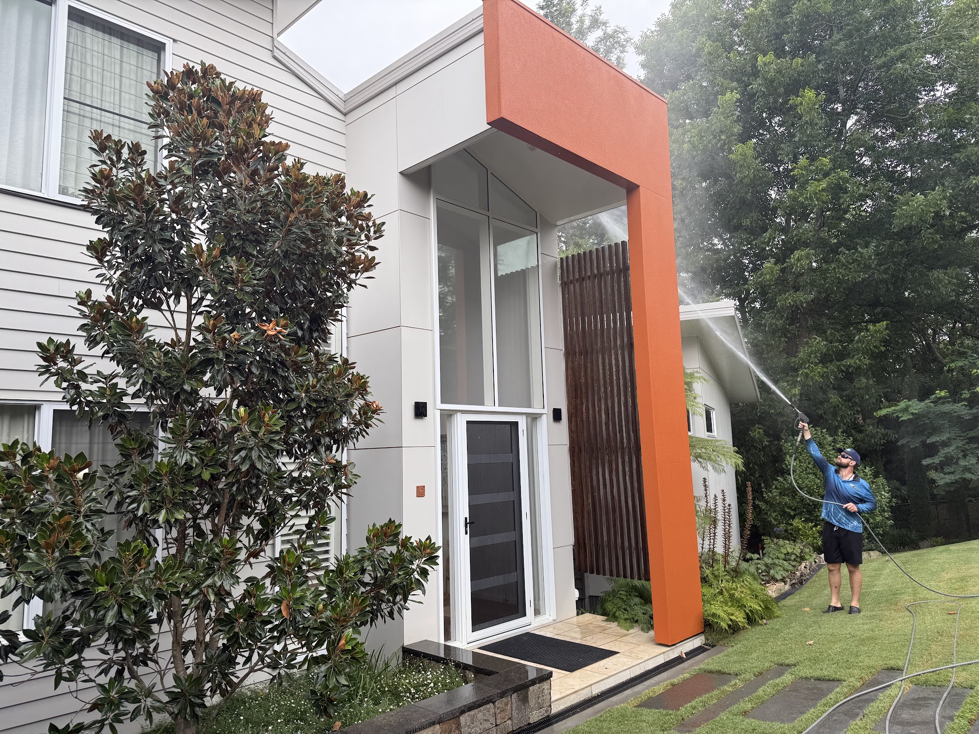 TopWash crew member washing the entry facade and feature wall of a modern Toowoomba home