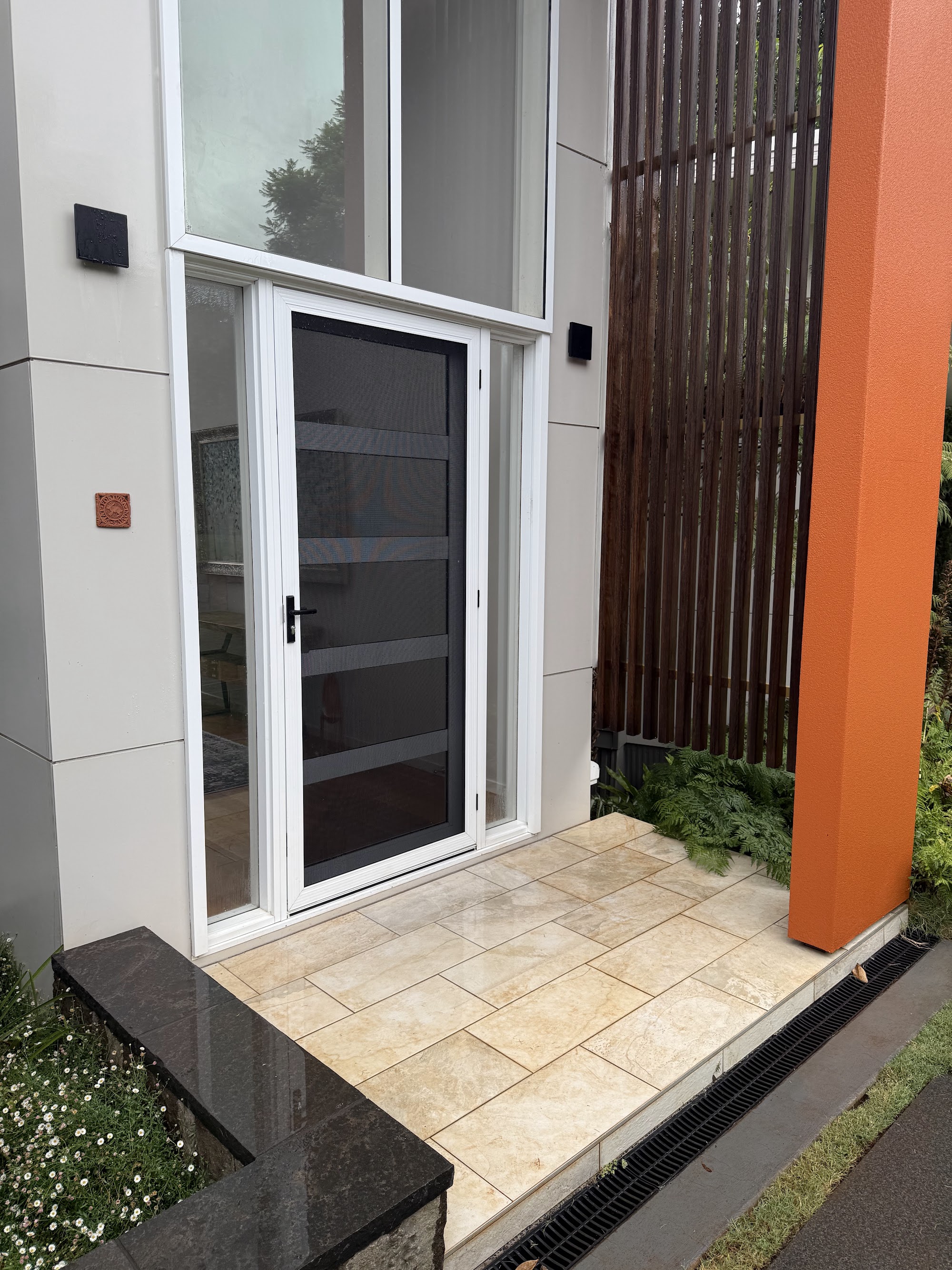 Tiled entry porch and glass entry door left clean after washing