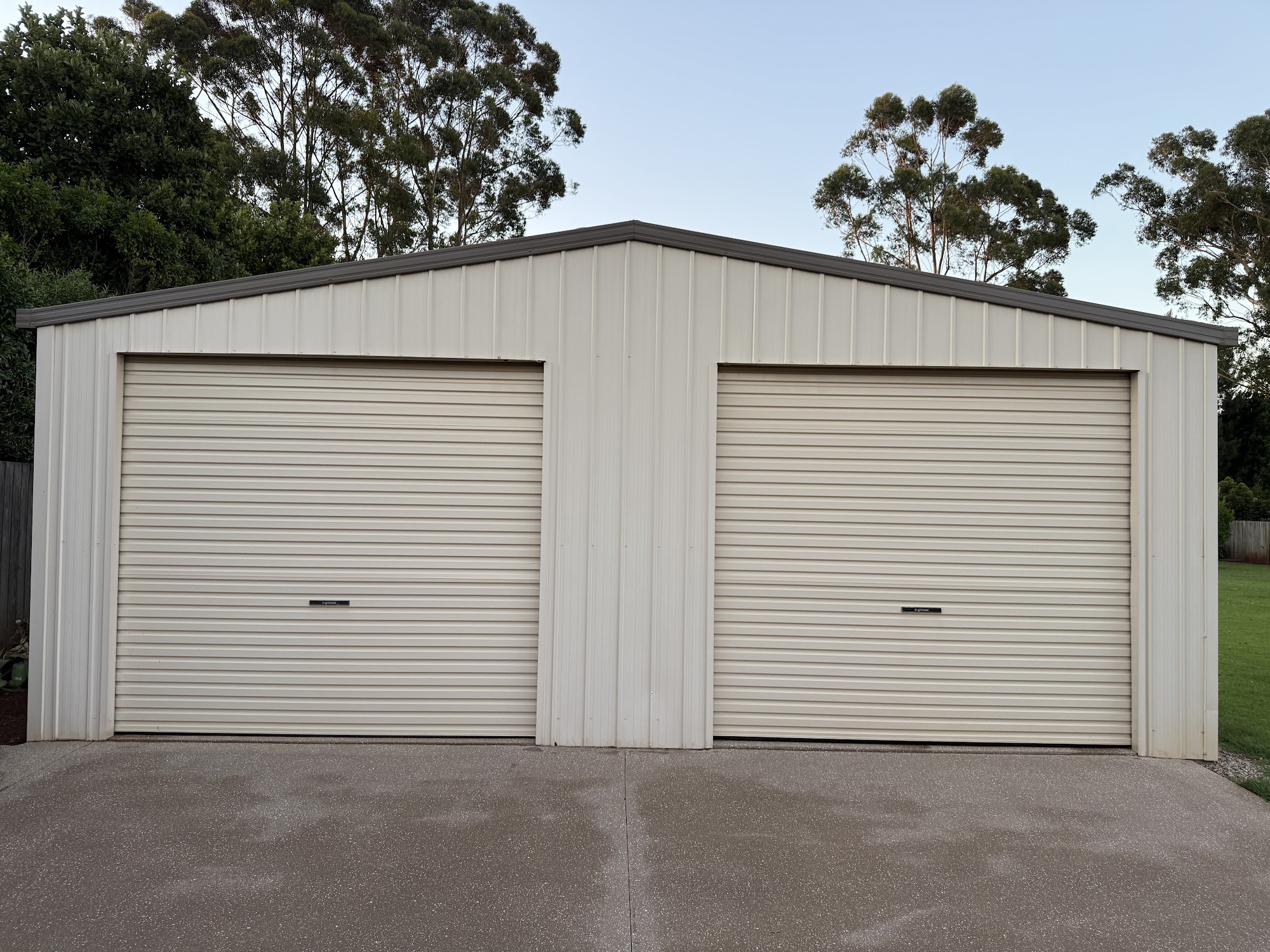 Double Colorbond garage shed and concrete apron after washing