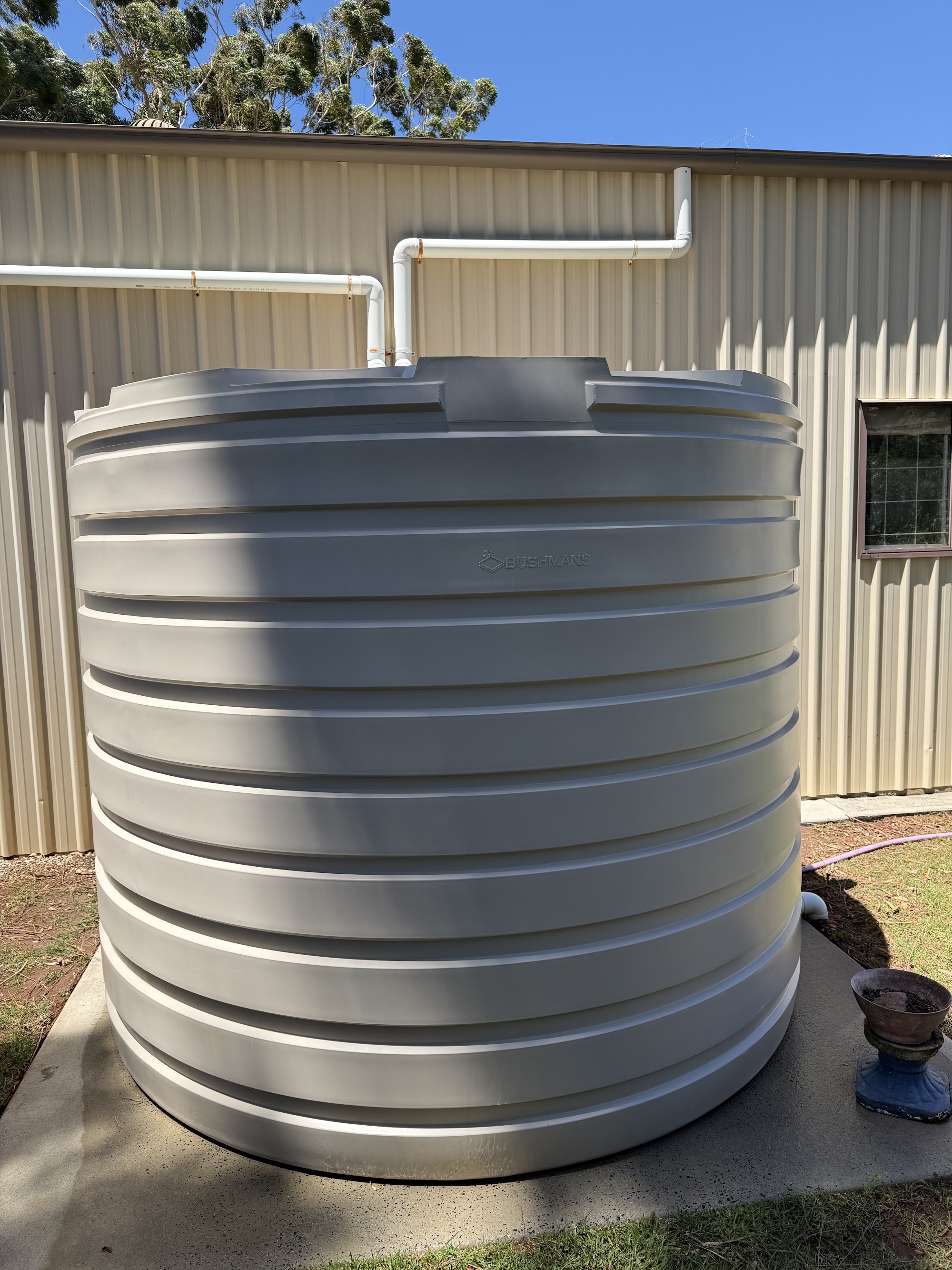 Rainwater tank exterior cleaned beside a Colorbond shed on the Darling Downs