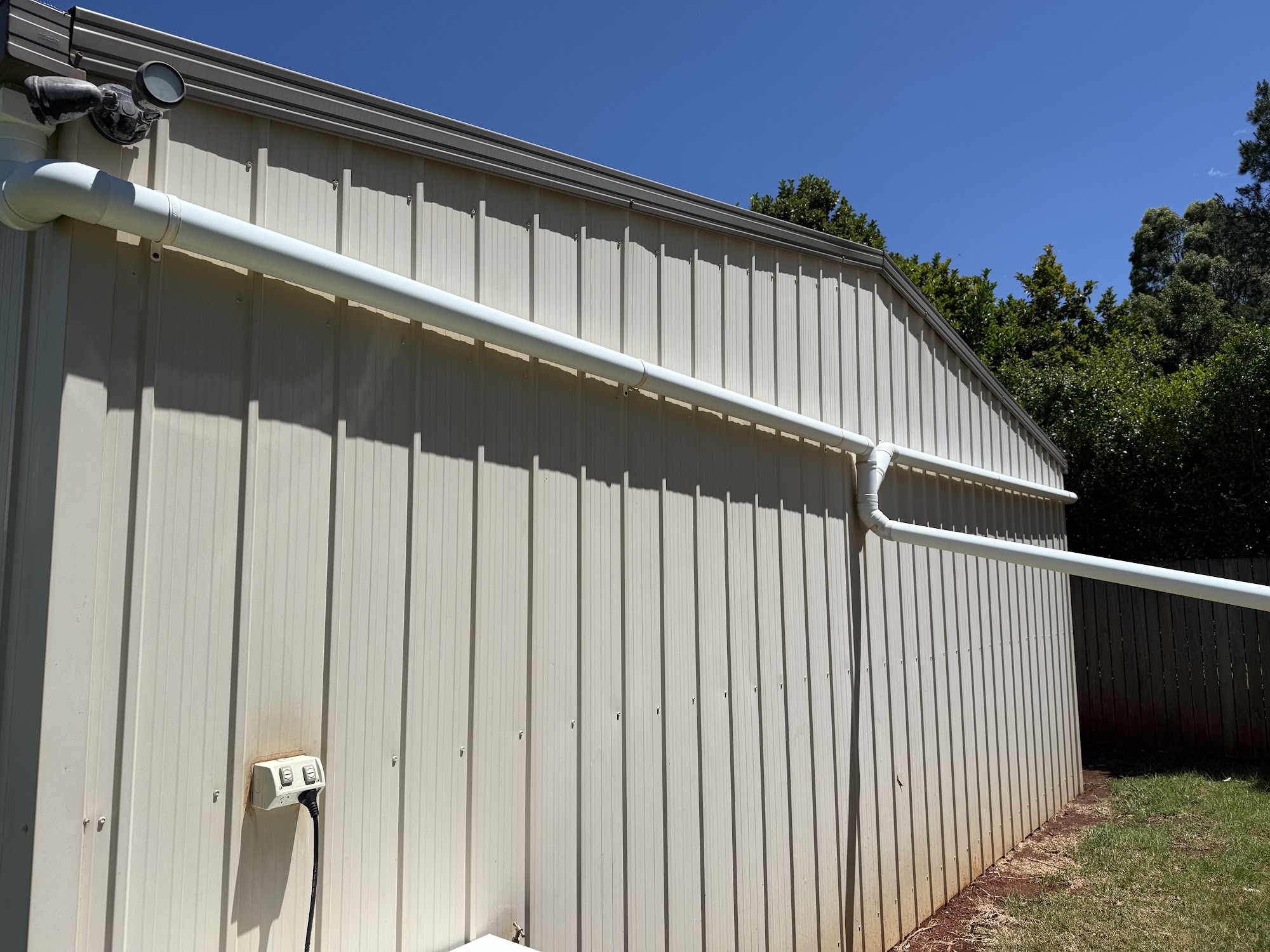 Colorbond shed wall, gutter and downpipe washed clean along the full length