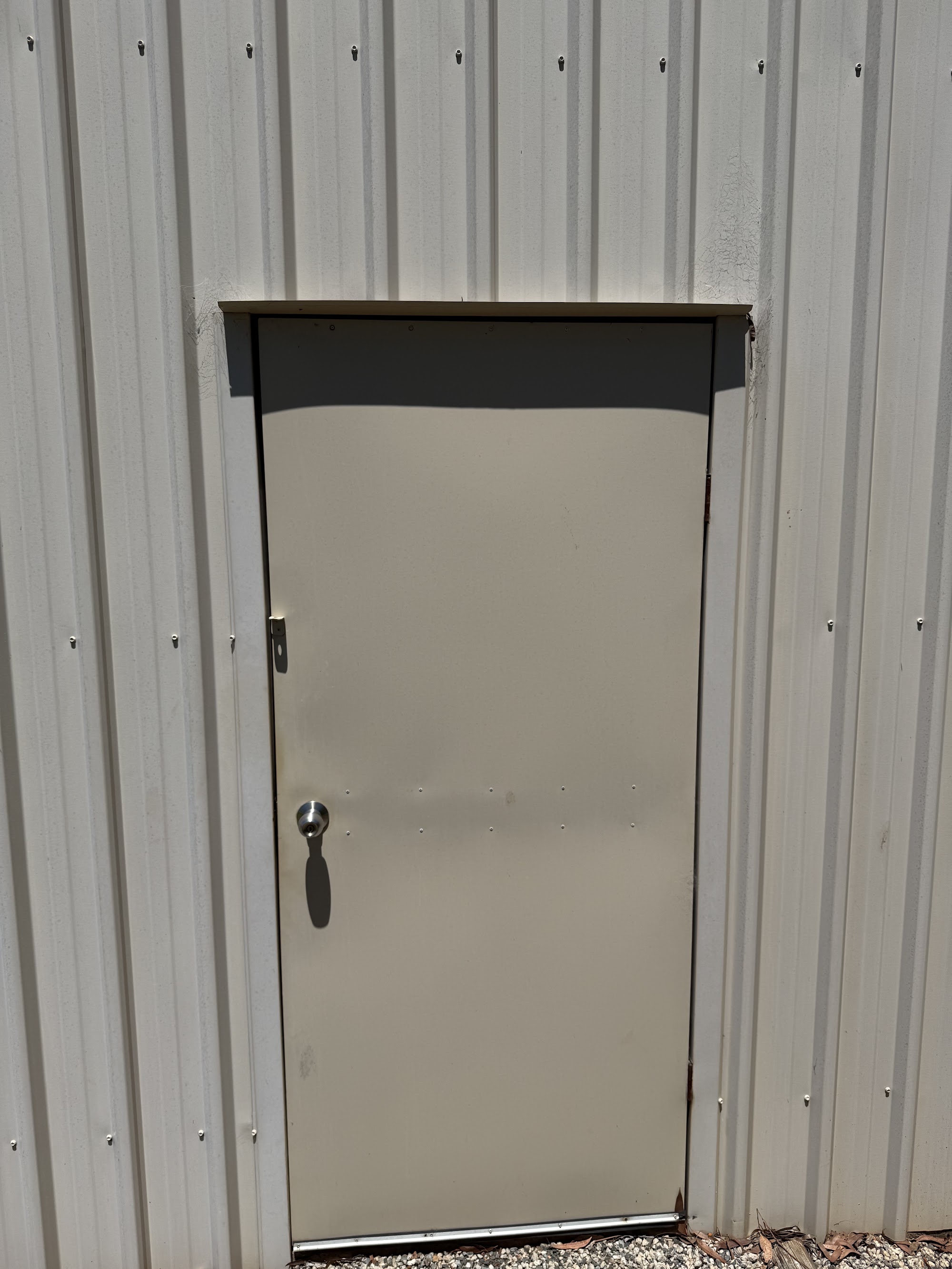 Shed door and wall sheeting marked with dirt before washing