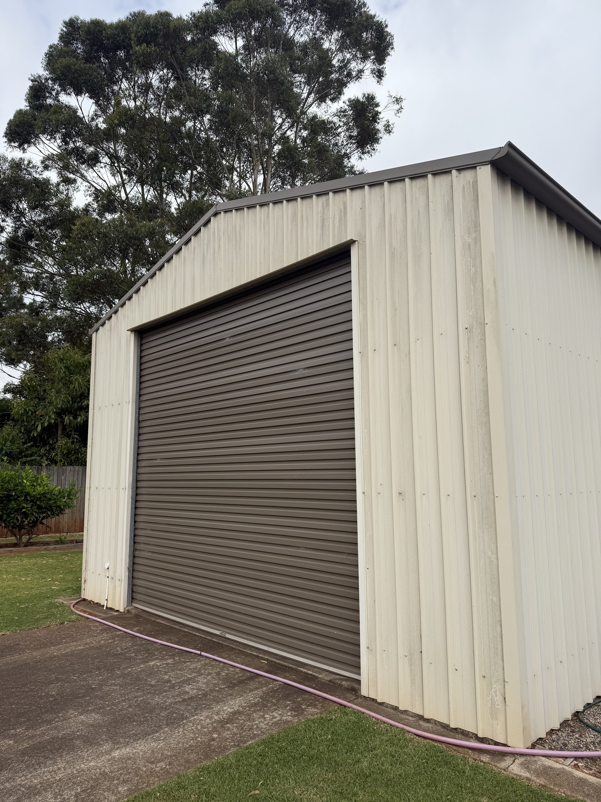 Colorbond shed streaked with weathering and grime before washing