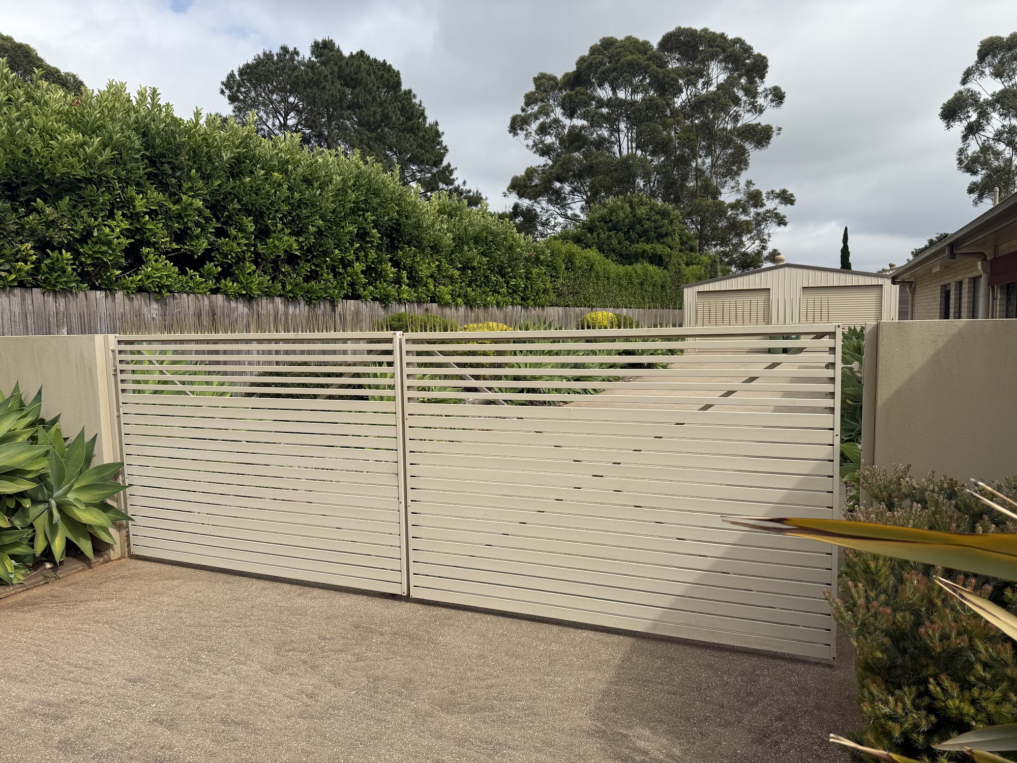 Aluminium slat driveway gates cleaned back to an even finish