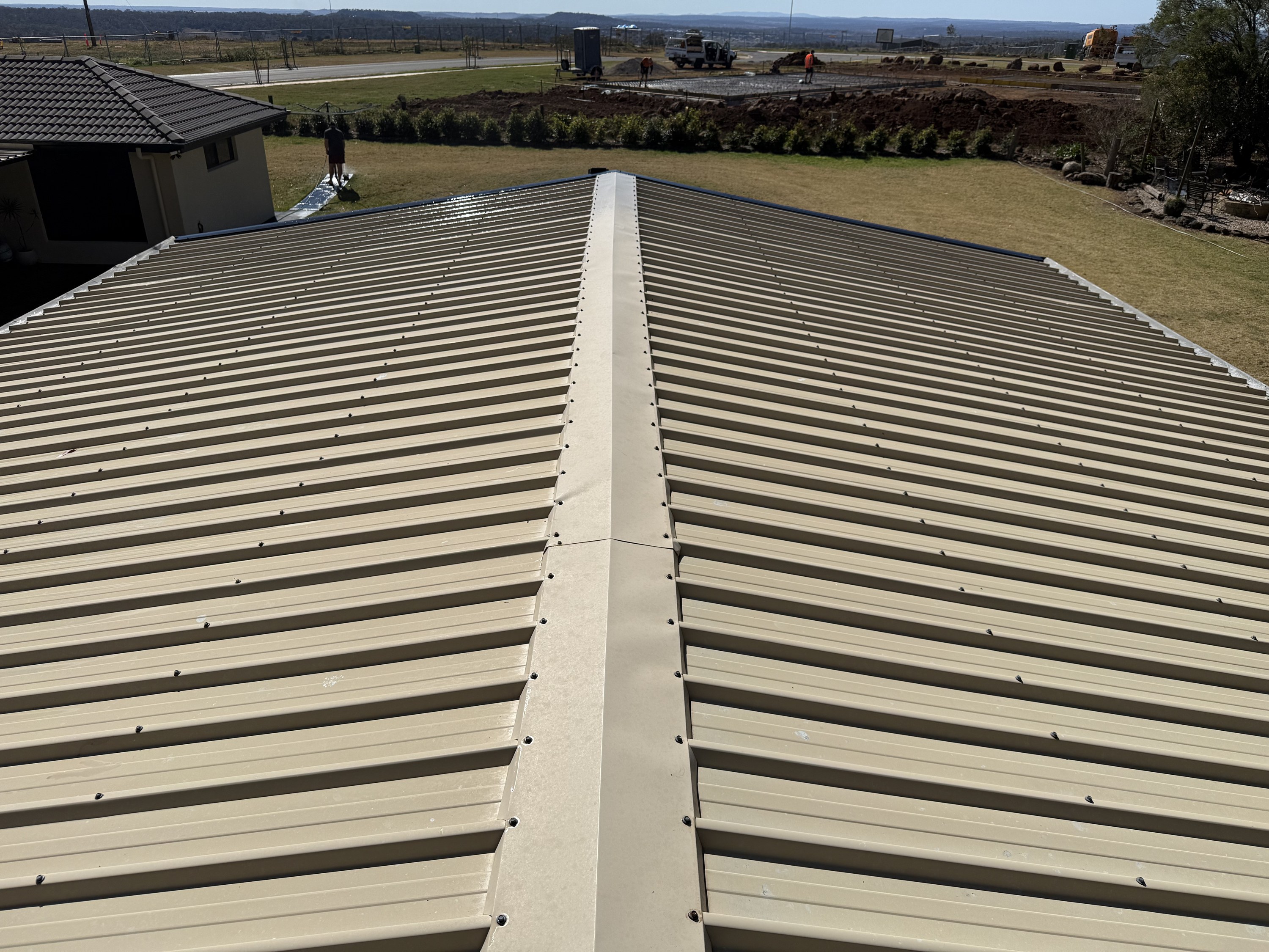 The same Colorbond roof after TopWash soft washing, back to clean beige