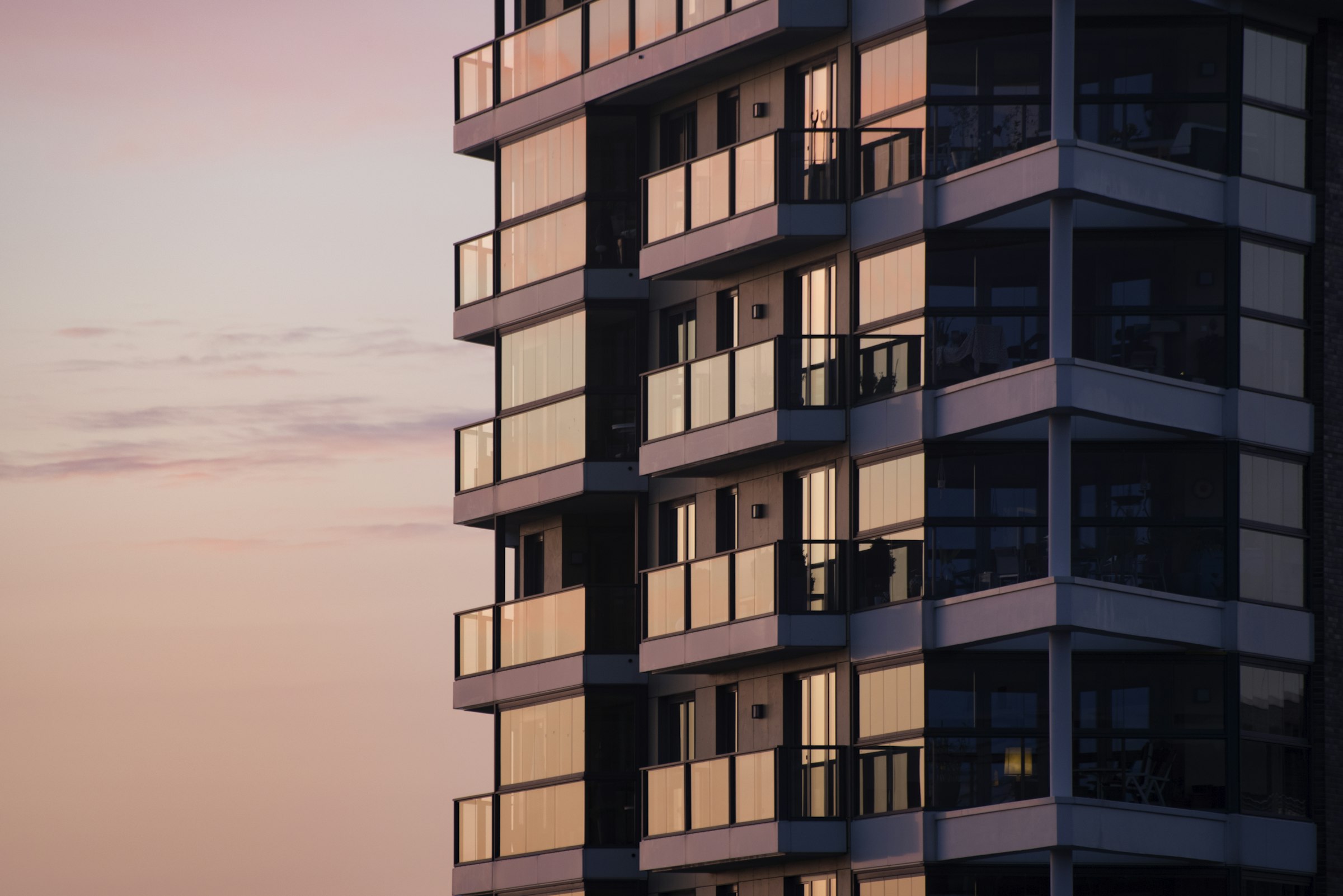 Modern institutional-quality apartment building at sunset