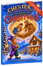 Book cover titled 'Chester the Jester Finds Christmas' by Nancy Thompson-Truitt, showing a joyful jester boy in colorful clothes looking up at a glowing image of Mary, Joseph, and baby Jesus, with a snowy log cabin and decorated Christmas tree in a wintery mountain landscape, and a red banner saying 'Coming Soon.'