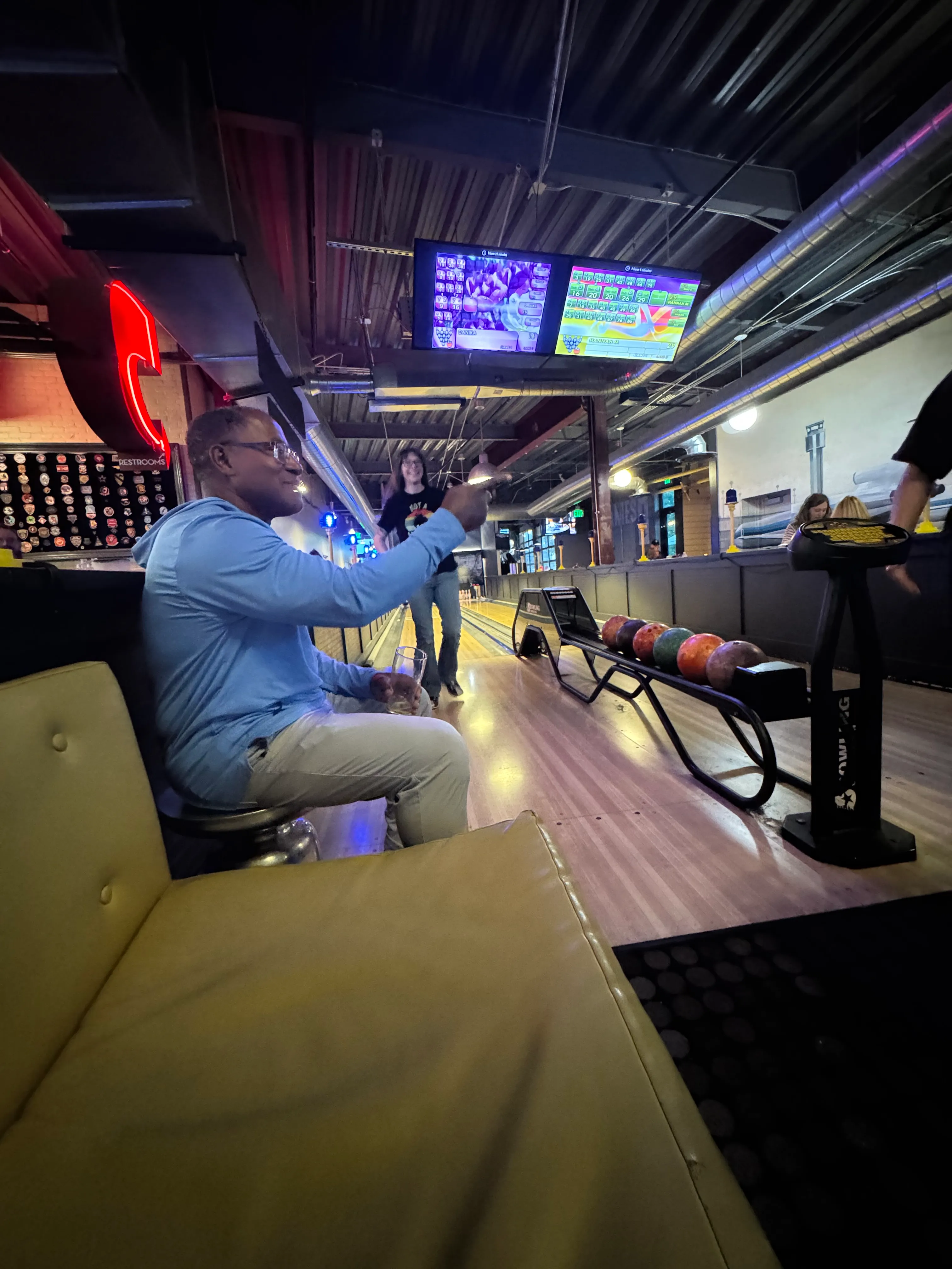 FlyteCo bowling photo 1: Oregon members sharing a lighthearted moment beside the bowling lanes in Denver.