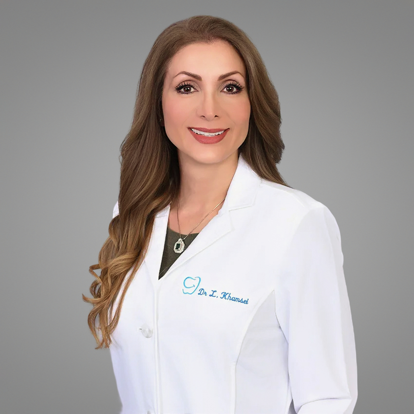 Dr. Leila Khamsei wearing her white dental coat