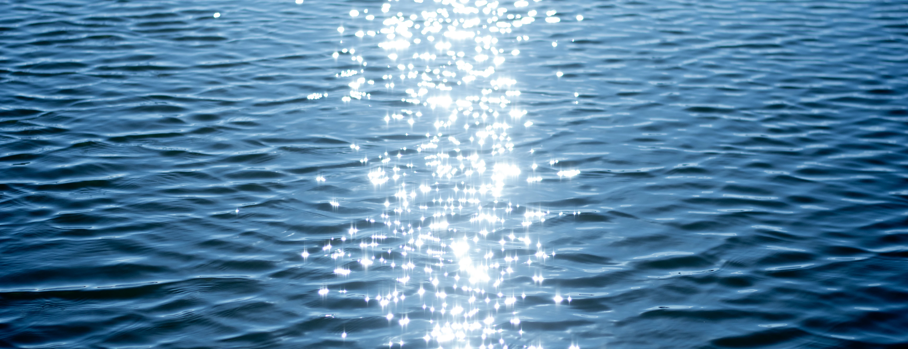 Sunlight sparkling across the open surface of a lake