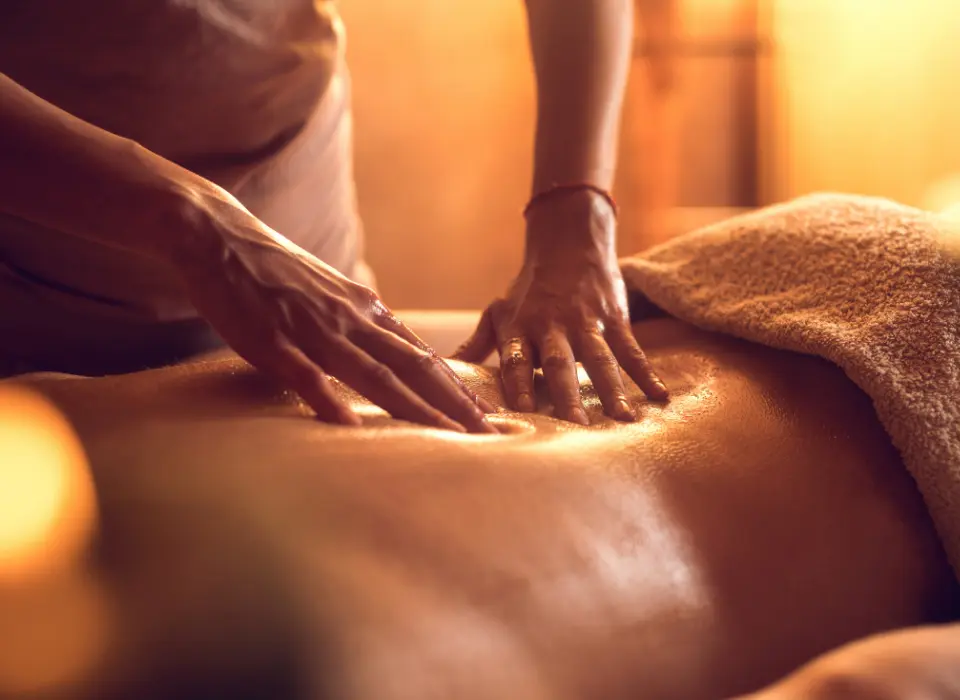 Serviettes roulées, bougies allumées et orchidée blanche dans un cabinet de massage