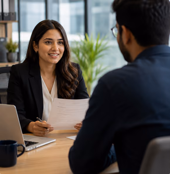 Two professionals in a meeting at a desk