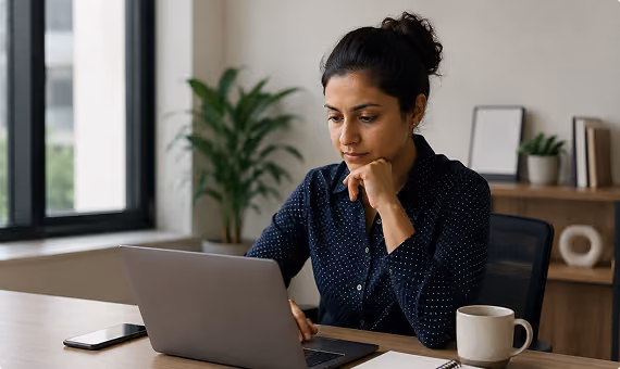 Professional woman working on a laptop at a desk