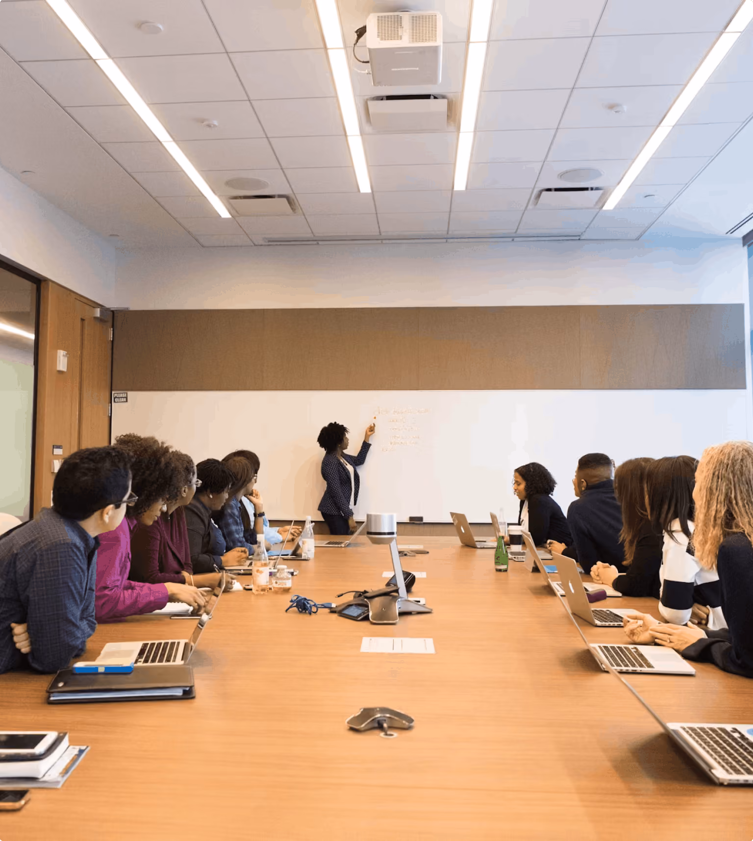Team of professionals attending a presentation in a corporate boardroom