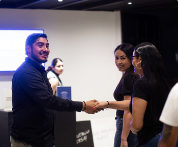 Professionals networking at a hiring or recruitment event