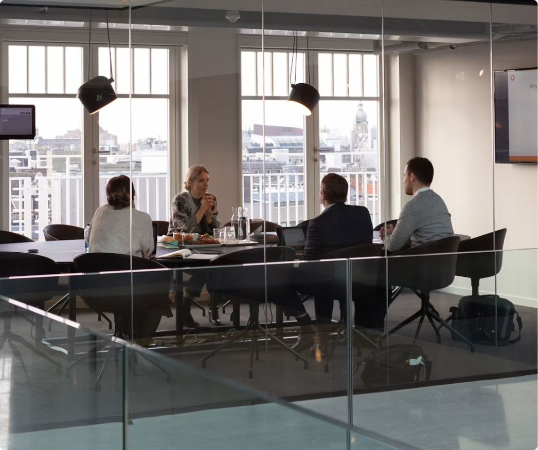 Professionals in a meeting room discussing talent strategy