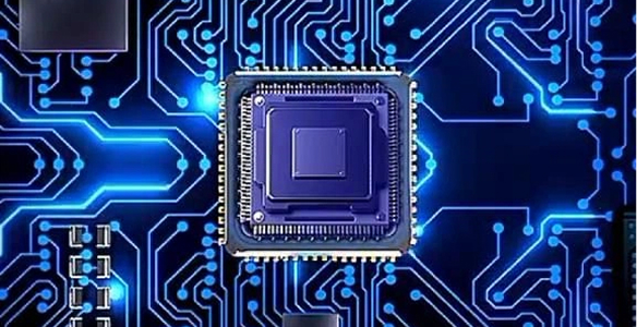 Close-up of a microchip on a blue illuminated circuit board