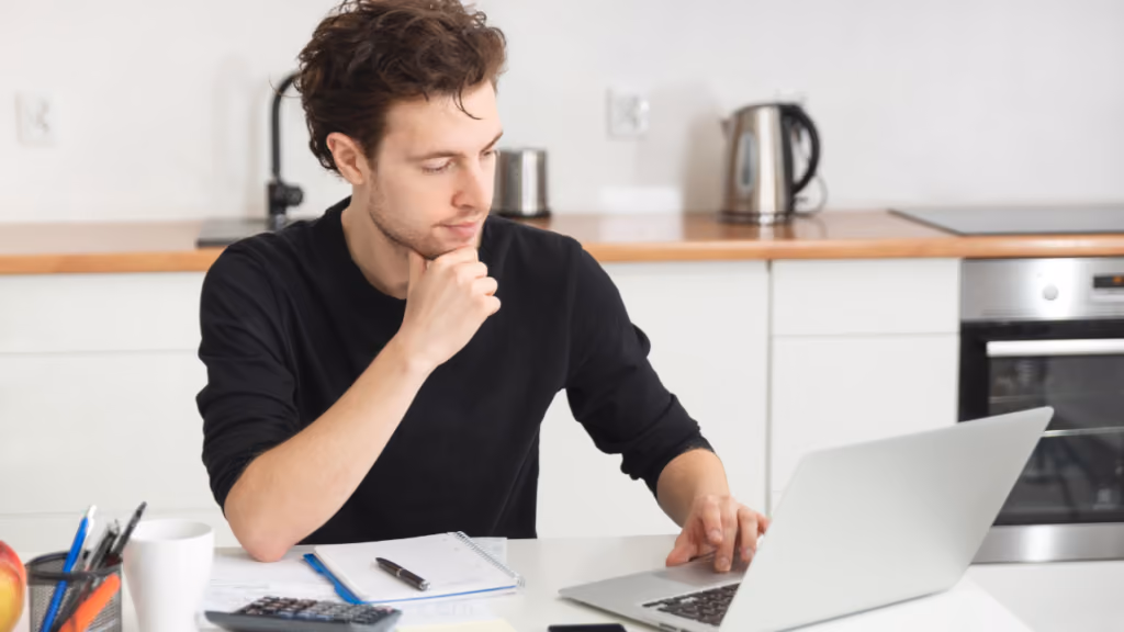 Professionnel utilisant un ordinateur portable avec un carnet et une calculatrice