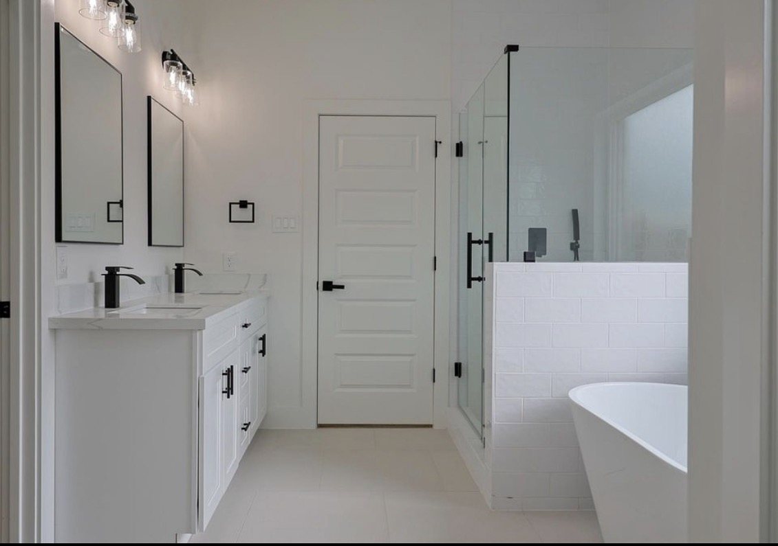 Remodeled primary bathroom with a freestanding tub and double vanity