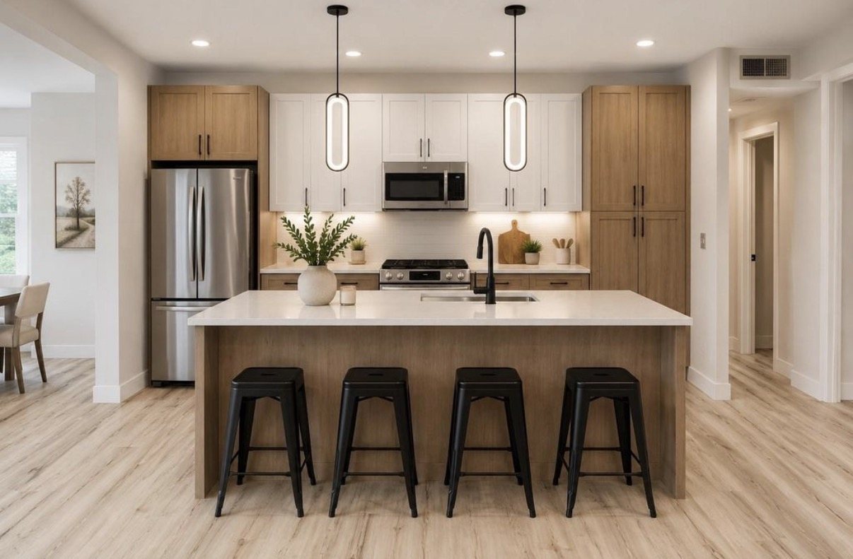Remodeled kitchen with a wood island, counter stools and pendant lighting